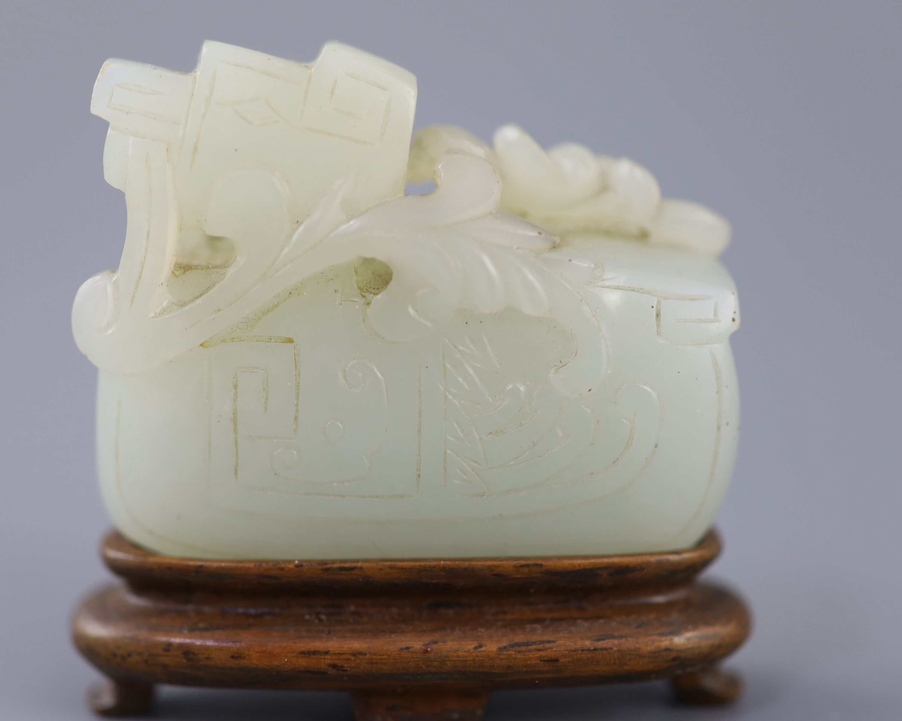 A Chinese archaistic pale celadon jade mandarin duck carving, 19th century, 5cm excluding wood stand